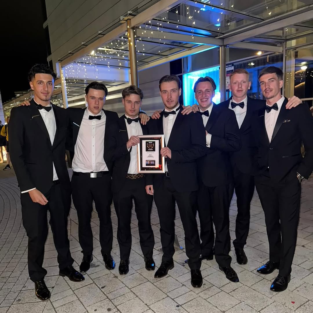 Darlins Barbers team on awards night holding the 2025 Best Barbers Northamptonshire trophy